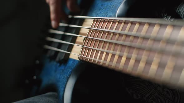 Bassplayer Plays with His Fingers on the Modern 5 String Bass in Slow Motion 1080p 240Fps
