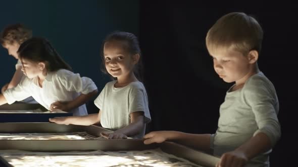 Girl Smiling during Sand Animation Class