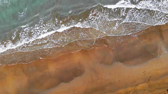 Aerial view of beach with breaking waves