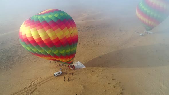 Aerial view of an hot-air-balloon being filling in the Murqquab desert, Dubai.