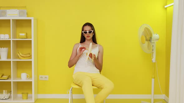 Young Woman Model Is Peeling Banana