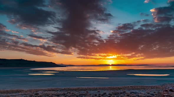 Sunset reflects off the water of the Great Salt Lake in this epic time lapse cloudscape