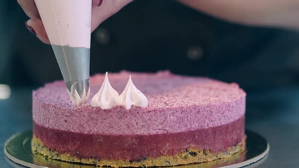 Confectioner Decorates Pink Biscuit Cake Using Pastry Bag
