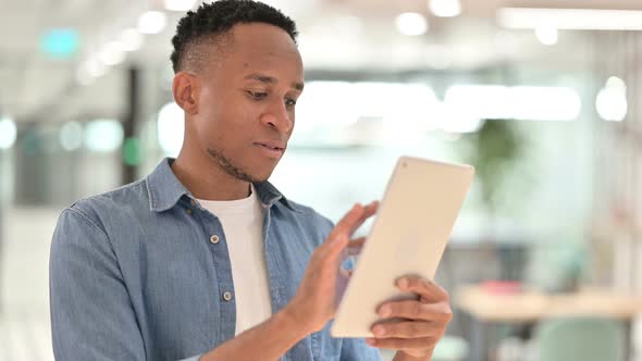 Portrait of Focused Casual African Man Using Digital Tablet