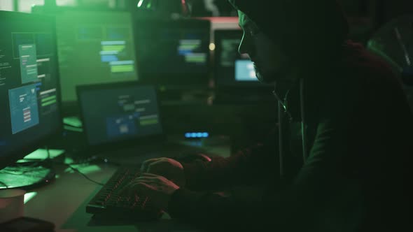 Black hat hacker working in his basement late at night