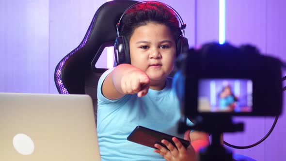 Asian Little Boy Holding Mobile Phone And Talking To Camera While Live Stream