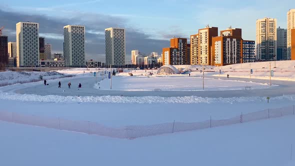 People IceSkating on IceRink in Park Within the City Limits