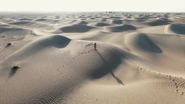 Blonde Woman is Posing and Walking Around in the Sand Rub Al Khali Desert