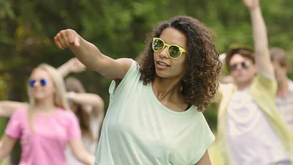 Beautiful Young Mixed Race Woman Moving to the Music at Party, Happiness