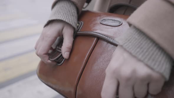 Woman leather sack with two golden metal rivets