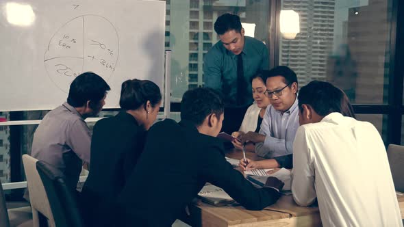 Asian Business People Discuss Marketing Strategy