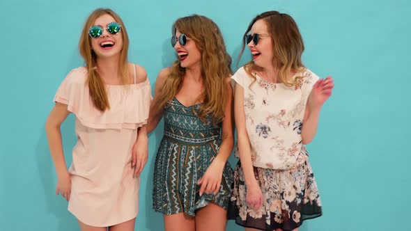 Three beautiful girls wearing summer hipster clothes