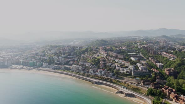 Cityscape of San Sebastian with sandy beach and blue sea coastline, aerial drone view
