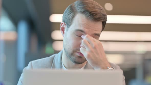 Close up of Man with Laptop having Headache