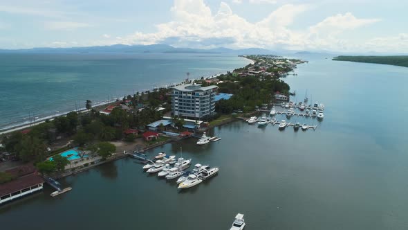 The highway separating the calm river and the sea in Puntarenas, Costa Rica. Aerial drone shot, pann