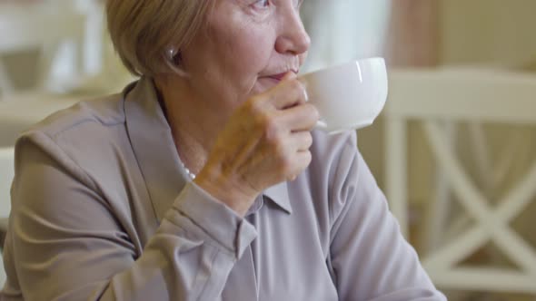 Elderly Woman Enjoying Coffee