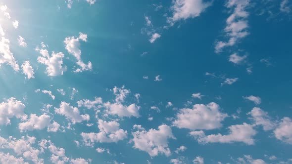 Timelapse Of Clouds Pass In Blue Sky With Sunflare