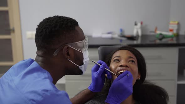 Young Africanamerican Woman Visiting Dentist's Office for Prevention and Treatment of the Oral