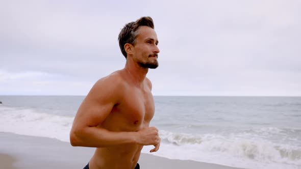 Athletic Man Exercising At The  Beach