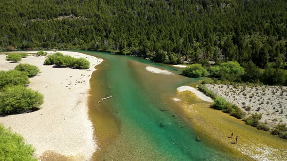 People fly fishing in Lake Cholila, Patagonia, Argentina, aerial forward flyover wide shot