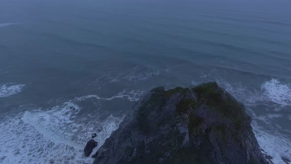 Drone flies up to a cliff, aerial view of Humboldt Lagoons, California, USA