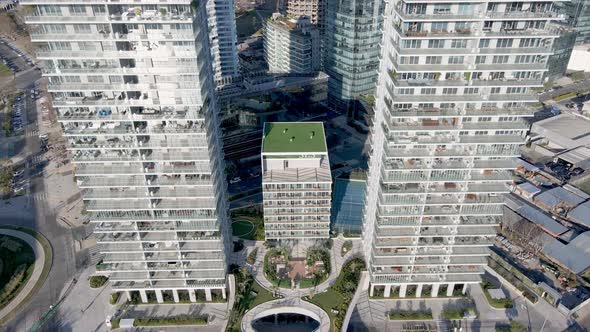 4K Aerial Drone Footage Looking Down at Apartments and Offices. Dolly Drone Shot Between Two Buildin