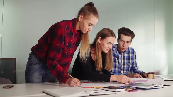 Group of Young Cool Hipster Designers in Casual Wear Working Together in Meeting Room Creating a