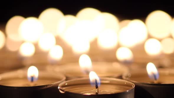 Many Candles Light on Black Background