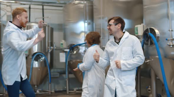 Happy Team of Scientists Dancing in Modern Brewery Plant