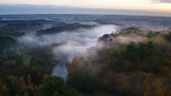 Foggy river and forest in autumn, view from above
