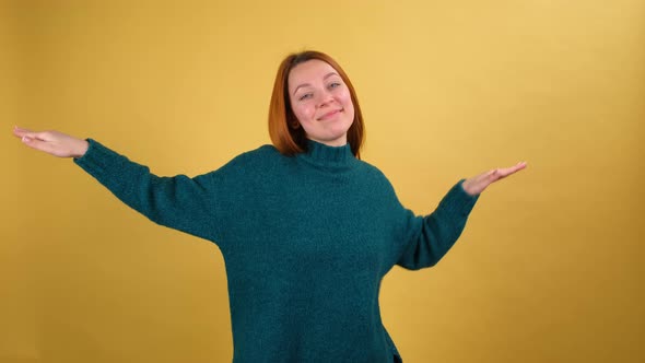 Young Red Hair Woman in Green Sweater Posing Isolated on Yellow Color Background Studio