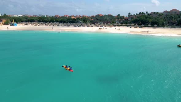 Couple Kayaking in the Ocean on Vacation Aruba Caribbean Sea Man and Woman Mid Age Kayak in Ocean