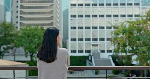 Woman look at the view with business tower background