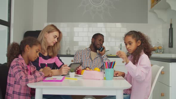 Diverse Family with Kids Relaxing at Kitchen Table