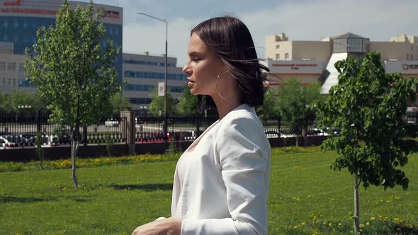 Stylish Woman Walking on Path in Park