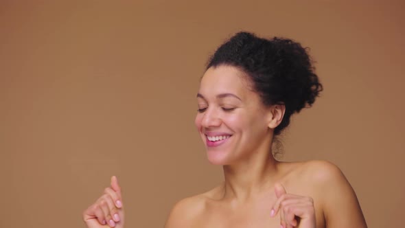 Beauty Portrait of Young African American Woman Merrily Dancing and Smiling