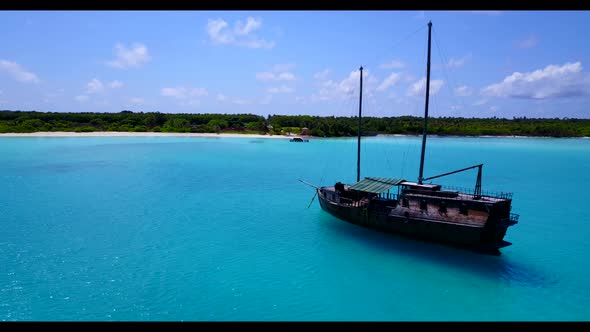 Aerial flying over seascape of relaxing seashore beach trip by turquoise ocean with clean sandy back