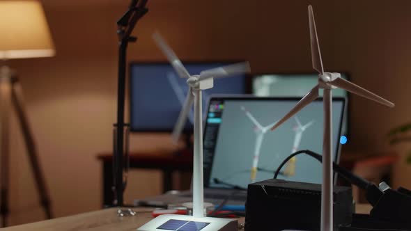 Close Up Of Small Wind Turbine With A Laptop Being Tested On The Table Next To The Solar Cell