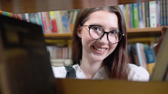 Close Up Attractive Teenage Girl Posing in Library Look at Camera