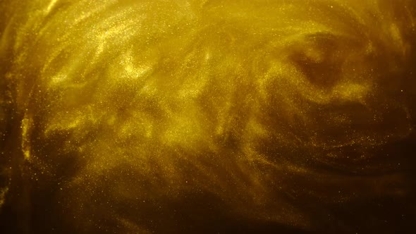 Golden Sand or Dust Creating Abstract Cloud Formations. Art Backgrounds.