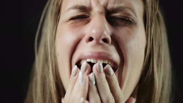 A Sad Beaten Up Woman with Tear in Eye and Bruises is Crying or Shouting