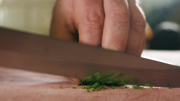 Close Up Macro Chef Man Chopping Cut Green Onion with Knife on Cutting Board Healthy Eating