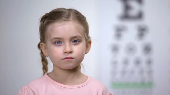 Cute Child Closing One Eye to Test Visual Acuity, Diagnostics of Sight Illness