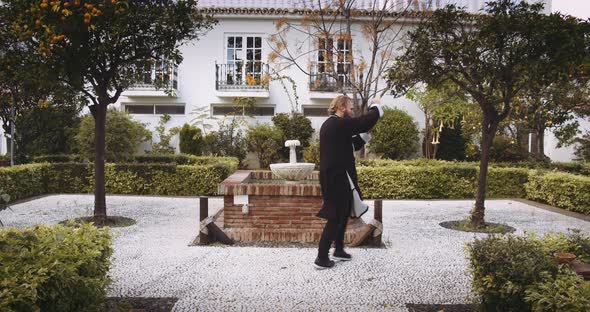 Man Performing Martial Arts In Formal Garden