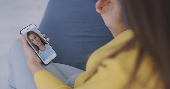 Young Woman Video Chatting with Friend Using Smartphone Waving Hand Greeting Sharing During Self