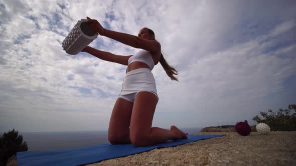 Well Looking Middle Aged Sporty Woman with Long Hair Fitness Instructor in White Sportswear Doing