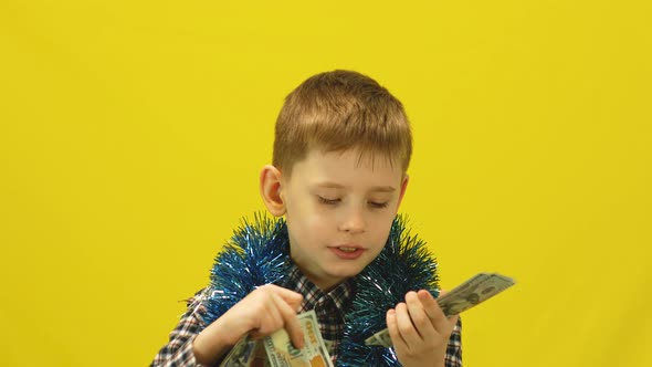 Cheerful Caucasian boy 8 years old holds in his hands and counts