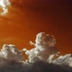 Fluffy clouds. 2 videos in 1 file.  White clouds moving through an orange and green sky. - VideoHive Item for Sale
