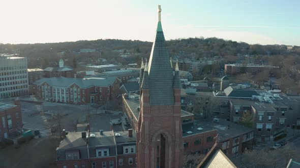 Aerial Drone Shot Orbiting a Brick Church Steeple in Suburban Boston