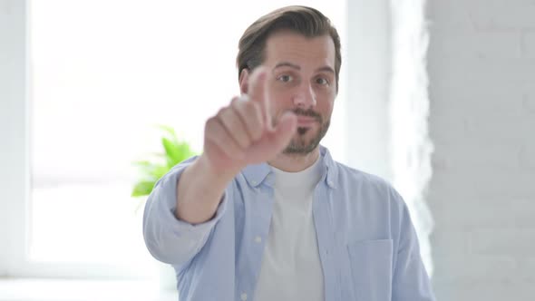 Portrait of Young Man Pointing at the Camera